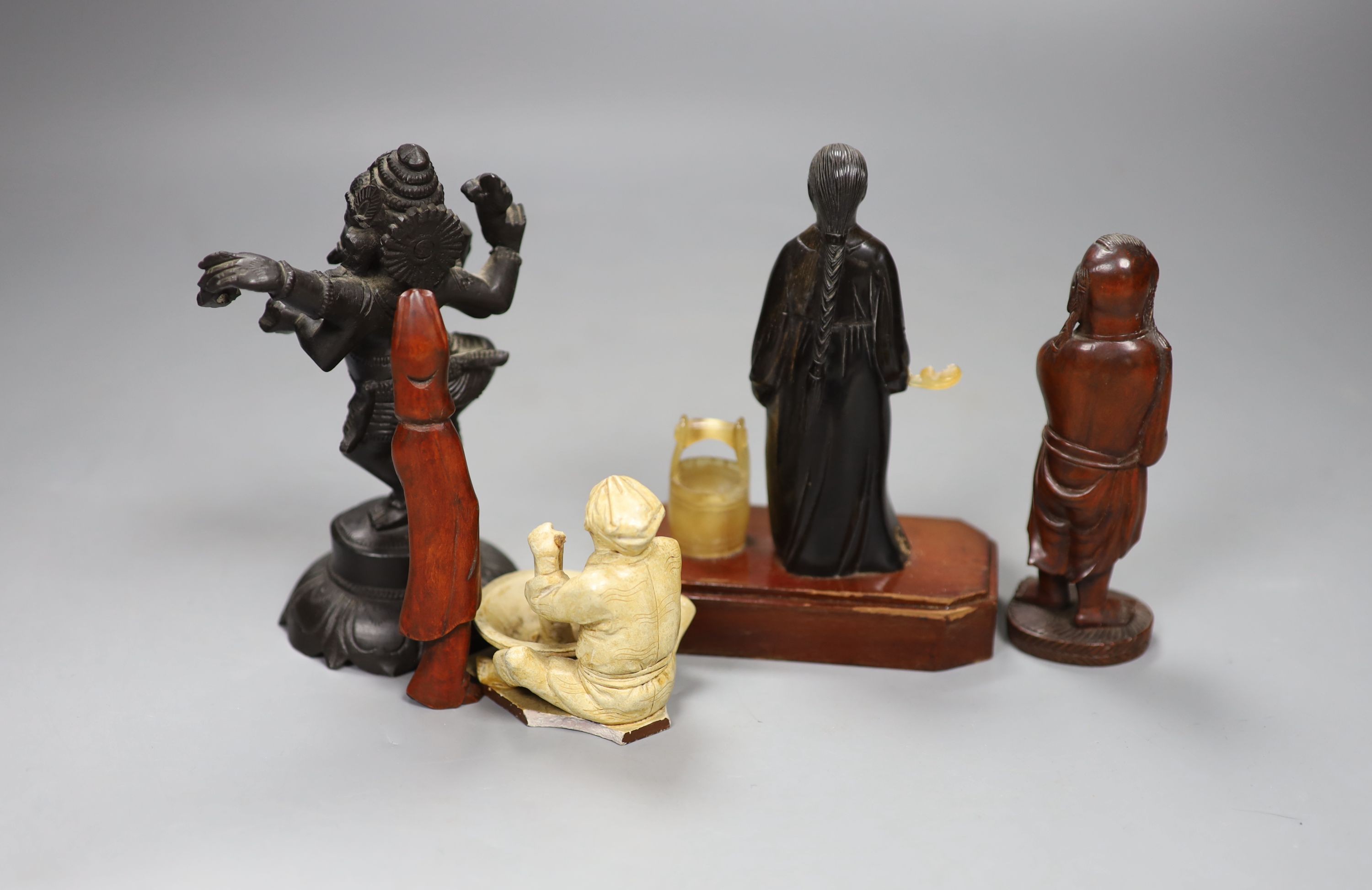 A Chinese horn figure of a lady, 14.3 cm high, two carved wood figures and A Japanese pottery seated figure